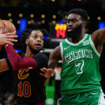 Dec 22, 2021; Boston, Massachusetts, USA; NBA; Cleveland Cavaliers guard Darius Garland (10) drives the ball against Boston Celtics guard Jaylen Brown (7) in the second quarter at TD Garden.