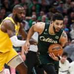 Jan 28, 2023; Boston, Massachusetts, USA; NBA; Boston Celtics forward Jayson Tatum (0) defended by Los Angeles Lakers forward LeBron James (6) during the first half at TD Garden.