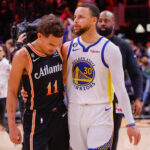 Mar 17, 2023; Atlanta, Georgia, USA; Atlanta Hawks guard Trae Young (11) talks to Golden State Warriors guard Stephen Curry (30) after a game at State Farm Arena.