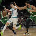Oct 19, 2023; Charlotte, North Carolina, USA; Charlotte Hornets guard LaMelo Ball (1) drives to the basket covered by Boston Celtics forward Jayson Tatum (0) during the second half at Spectrum Center.