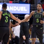 Dec 1, 2023; New Orleans, Louisiana, USA; New Orleans Pelicans forward Herbert Jones (5) is congratulated by guard CJ McCollum (3) after. Making a basket against the San Antonio Spurs during the second half at the Smoothie King Center.
