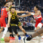 Dec 22, 2023; San Francisco, California, USA; Golden State Warriors guard Stephen Curry (30) dribbles away from pressure by Washington Wizards guard Jordan Poole (13) during the first quarter at Chase Center.