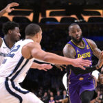 Jan 5, 2024; Los Angeles, California, USA; NBA; Memphis Grizzlies forward Jaren Jackson Jr. (13) and guard Desmond Bane (22) defend Los Angeles Lakers forward LeBron James (23) in the first half at Crypto.com Arena.