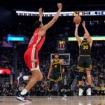 Jan 10, 2024; San Francisco, California, USA; Golden State Warriors guard Stephen Curry (30) shoots over New Orleans Pelicans forward Trey Murphy III (25) in the second quarter at the Chase Center.