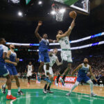 Jan 10, 2024; Boston, Massachusetts, USA; NBA; Boston Celtics forward Jayson Tatum (0) goes to the basket past Minnesota Timberwolves guard Anthony Edwards (5) during the second half at TD Garden.