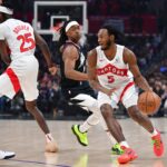 Jan 10, 2024; Los Angeles, California, USA; Toronto Raptors guard Immanuel Quickley (5) moves the ball as forward Chris Boucher (25) provides coverage against Los Angeles Clippers guard Terance Mann (14) during the first half at Crypto.com Arena. Mandatory Credit: Gary A. Vasquez-USA TODAY Sports
