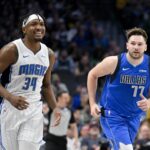 Jan 29, 2024; Dallas, Texas, USA; Orlando Magic center Wendell Carter Jr. (34) and Dallas Mavericks guard Luka Doncic (77) run back up the court during the first quarter at the American Airlines Center.