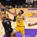 Feb 13, 2024; Los Angeles, California, USA; Los Angeles Lakers forward Christian Wood (35) blocks a shot by Detroit Pistons guard Cade Cunningham (2) in the second half at Crypto.com Arena. Mandatory Credit: Jayne Kamin-Oncea-USA TODAY Sports