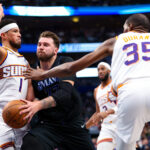 Feb 22, 2024; Dallas, Texas, USA; Dallas Mavericks guard Luka Doncic (77) drives to the basket as Phoenix Suns guard Devin Booker (1) and Phoenix Suns forward Kevin Durant (35) defend during the first quarter at American Airlines Center.