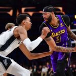 Feb 23, 2024; Los Angeles, California, USA; Los Angeles Lakers forward Anthony Davis (3) moves the ball against San Antonio Spurs center Victor Wembanyama (1) during the first half at Crypto.com Arena.