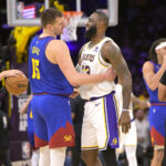 Mar 2, 2024; Los Angeles, California, USA; Los Angeles Lakers forward LeBron James (23) is greeted by Denver Nuggets center Nikola Jokic (15) at the start of the game at Crypto.com Arena.