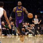 Mar 22, 2024; Los Angeles, California, USA; Los Angeles Lakers forward LeBron James (23) dribbles the ball against Philadelphia 76ers guard Kyle Lowry (7) during the fourth quarter at Crypto.com Arena.