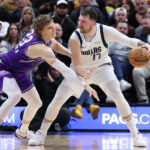 Mar 25, 2024; Salt Lake City, Utah, USA; Dallas Mavericks guard Luka Doncic (77) dribbles against Utah Jazz forward Lauri Markkanen (23) during the fourth quarter at Delta Center.