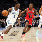 Mar 31, 2024; Minneapolis, Minnesota, USA; Minnesota Timberwolves guard Anthony Edwards (5) works around Chicago Bulls guard Ayo Dosunmu (12) during the first half at Target Center.
