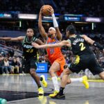Apr 5, 2024; Indianapolis, Indiana, USA; Oklahoma City Thunder guard Aaron Wiggins (21) shoots the ball while Indiana Pacers forward Aaron Nesmith (23) and guard Andrew Nembhard (2) defend in the second half at Gainbridge Fieldhouse. Mandatory Credit: Trevor Ruszkowski-USA TODAY Sports