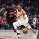 Apr 17, 2024; Chicago, Illinois, USA; Chicago Bulls guard Javonte Green (24) defends Atlanta Hawks guard Trae Young (11) during the second half during a play-in game of the 2024 NBA playoffs at United Center. Mandatory Credit: David Banks-USA TODAY Sports