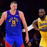 Apr 25, 2024; Los Angeles, California, USA; Denver Nuggets center Nikola Jokic (15) controls the ball against Los Angeles Lakers forward LeBron James (23) during the second half in game three of the first round for the 2024 NBA playoffs at Crypto.com Arena.