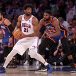 Apr 30, 2024; New York, New York, USA; Philadelphia 76ers center Joel Embiid (21) handles the ball against New York Knicks center Mitchell Robinson (23) during overtime in game 5 of the first round of the 2024 NBA playoffs at Madison Square Garden.