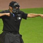 Sep 18, 2024; Cleveland, Ohio, USA; Home plate umpire Chad Fairchild (4) calls a third strike during a game between the Cleveland Guardians and the Minnesota Twins at Progressive Field. Mandatory Credit: David Richard-Imagn Images
