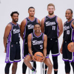 Sep 30, 2024; Sacramento, CA, USA; Sacramento Kings guard Malik Monk (0) and forward Keegan Murray (13) and forward Domantas Sabonis (11) and forward DeMar DeRozan (10) and guard De'Aaron Fox (5) pose for a photo during media day at Golden 1 Center.