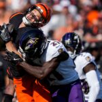 NFL; Cincinnati Bengals tight end Mike Gesicki (88) is hit hard by Baltimore Ravens defensive back Brandon Stephens (21) as he catches a pass for a first down in the third quarter of the NFL Week 5 game between the Cincinnati Bengals and Baltimore Ravens at Paycor Stadium in downtown Cincinnati on Sunday, Oct. 6, 2024. The Bengals fell to 1-4 on the season with a 41-38 loss to the Ravens.