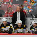 Oct 8, 2024; Sunrise, Florida, USA; Boston Bruins head coach Jim Montgomery looks on from the bench against the Florida Panthers during the third period at Amerant Bank Arena.