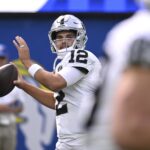 Oct 20, 2024; Inglewood, California, USA; Las Vegas Raiders quarterback Aidan O'Connell (12) throws a pass during warmups before the game against the Los Angeles Rams at SoFi Stadium. Mandatory Credit: Alex Gallardo-Imagn Images