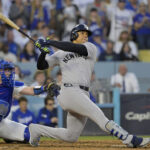 Oct 26, 2024; Los Angeles, California, USA; New York Yankees outfielder Juan Soto (22) hits a solo home run in the third inning against the Los Angeles Dodgers during game two of the 2024 MLB World Series at Dodger Stadium. Mandatory Credit: Jayne Kamin-Oncea-Imagn Images