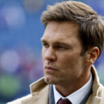 Oct 27, 2024; Seattle, Washington, USA; FOX commentator Tom Brady stands on the sideline before a game between the Seattle Seahawks and Buffalo Bills at Lumen Field. Mandatory Credit: Joe Nicholson-Imagn Images