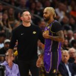 Oct 28, 2024; Phoenix, Arizona, USA; Los Angeles Lakers head coach JJ Redick with guard D'Angelo Russell (1) against the Phoenix Suns at Footprint Center. Mandatory Credit: Mark J. Rebilas-Imagn Images