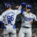 Oct 30, 2024; New York, New York, USA; Los Angeles Dodgers third baseman Enrique Hernandez (8) celebrates with first base coach Clayton McCullough (86) during the fifth inning against the New York Yankees in game five of the 2024 MLB World Series at Yankee Stadium. Mandatory Credit: Vincent Carchietta-Imagn Images