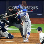 Oct 30, 2024; New York, New York, USA, Silver Slugger; Los Angeles Dodgers shortstop Mookie Betts (50) hits a sacrifice fly during the eighth inning against the New York Yankees in game four of the 2024 MLB World Series at Yankee Stadium. Mandatory Credit: Robert Deutsch-Imagn Images