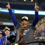 Oct 30, 2024; New York, New York, USA; Los Angeles Dodgers manager Dave Roberts (30) celebrates after winning the 2024 MLB World Series against the New York Yankees at Yankee Stadium. Mandatory Credit: Vincent Carchietta-Imagn Images