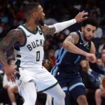 Oct 31, 2024; Memphis, Tennessee, USA; Memphis Grizzlies guard Scotty Pippen Jr. (1) drives to the basket as Milwaukee Bucks guard Damian Lillard (0) defends during the second half at FedExForum. Mandatory Credit: Petre Thomas-Imagn Images