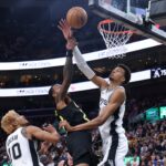 Oct 31, 2024; Salt Lake City, Utah, USA; Utah Jazz forward John Collins (20) goes to the basket against San Antonio Spurs center Victor Wembanyama (1) during the third quarter at Delta Center.
