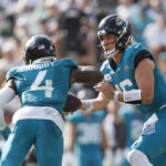 Oct 27, 2024; Jacksonville, Florida, USA;, Draft; Jacksonville Jaguars quarterback Trevor Lawrence (16) hands the ball off to running back Tank Bigsby (4) against the Green Bay Packers during the third quarter at EverBank Stadium. Mandatory Credit: Morgan Tencza-Imagn Images