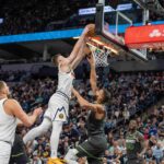 Nov 1, 2024; Minneapolis, Minnesota, USA; Denver Nuggets guard Christian Braun (0) dunks over Minnesota Timberwolves center Rudy Gobert (27) both players would pick up flagrant fouls when a fight breaks out after the play in the fourth quarter at Target Center. Mandatory Credit: Matt Blewett-Imagn Images