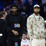 Nov 2, 2024; Philadelphia, Pennsylvania, USA; NBA; Injured Philadelphia 76ers Paul George (R) and Joel Embiid (L) look on during the first quarter against the Memphis Grizzlies at Wells Fargo Center.