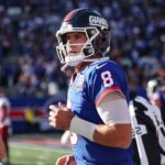 Nov 3, 2024; East Rutherford, New Jersey, USA; New York Giants quarterback Daniel Jones (8) runs of fetch field after throwing a touchdown pass during the first half against the Washington Commanders at MetLife Stadium.