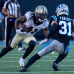 Nov 3, 2024; Charlotte, North Carolina, USA; New Orleans Saints running back Alvin Kamara (41) runs the ball against Carolina Panthers cornerback Caleb Farley (31) during the fourth quarter at Bank of America Stadium. Mandatory Credit: Scott Kinser-Imagn Images
