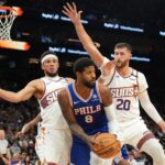 Nov 4, 2024; Phoenix, Arizona, USA; Phoenix Suns guard Devin Booker (1) and Phoenix Suns center Jusuf Nurkic (20) guard Philadelphia 76ers forward Paul George (8) during the second half at Footprint Center. Mandatory Credit: Joe Camporeale-Imagn Images