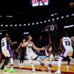 Nov 4, 2024; Miami, Florida, USA; Sacramento Kings forward Domantas Sabonis (11) shoots the game-winning basket over Miami Heat center Bam Adebayo (13) during the fourth quarter at Kaseya Center. Mandatory Credit: Sam Navarro-Imagn Images
