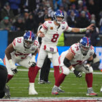 Nov 10, 2024; Munich, Germany; New York Giants quarterback Daniel Jones (8) prepares to take the snap against the Carolina Panthers in the first half during the 2024 NFL Munich Game at Allianz Arena. Mandatory Credit: Kirby Lee-Imagn Images