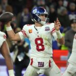 Nov 10, 2024; Munich, Germany; New York Giants quarterback Daniel Jones (8) throws the ball against the Carolina Panthers in the second half during the 2024 NFL Munich Game at Allianz Arena. Mandatory Credit: Kirby Lee-Imagn Images