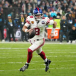 Nov 10, 2024; Munich, Germany; New York Giants quarterback Daniel Jones (8) carries the ball against the New York Giants in the second half during the 2024 NFL Munich Game at Allianz Arena. Mandatory Credit: Kirby Lee-Imagn Images