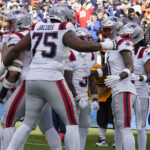 Nov 10, 2024; Chicago, Illinois, USA; New England Patriots wide receiver Ja'Lynn Polk (1) celebrates after catching a touchdown pass against the Chicago Bears during the first half at Soldier Field. Mandatory Credit: David Banks-Imagn Images