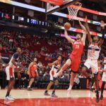 Nov 11, 2024; Houston, Texas, USA; Houston Rockets center Alperen Sengun (28) scores against Washington Wizards forward Alexandre Sarr (20) in the first quarter at Toyota Center. Mandatory Credit: Thomas Shea-Imagn Images