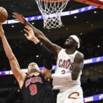 Nov 11, 2024; Chicago, Illinois, USA; Chicago Bulls center Nikola Vucevic (9) shoots against Cleveland Cavaliers guard Caris LeVert (3) during the second half at United Center. Mandatory Credit: Matt Marton-Imagn Images