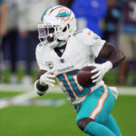 Nov 11, 2024; Inglewood, California, USA; Miami Dolphins wide receiver Tyreek Hill (10) carries the ball against the Los Angeles Rams in the second half at SoFi Stadium. Mandatory Credit: Kirby Lee-Imagn Images
