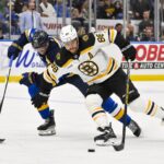 Nov 12, 2024; St. Louis, Missouri, USA; Boston Bruins right wing David Pastrnak (88) skates against St. Louis Blues defenseman Pierre-Olivier Joseph (77) during the third period at Enterprise Center. Mandatory Credit: Jeff Curry-Imagn Images